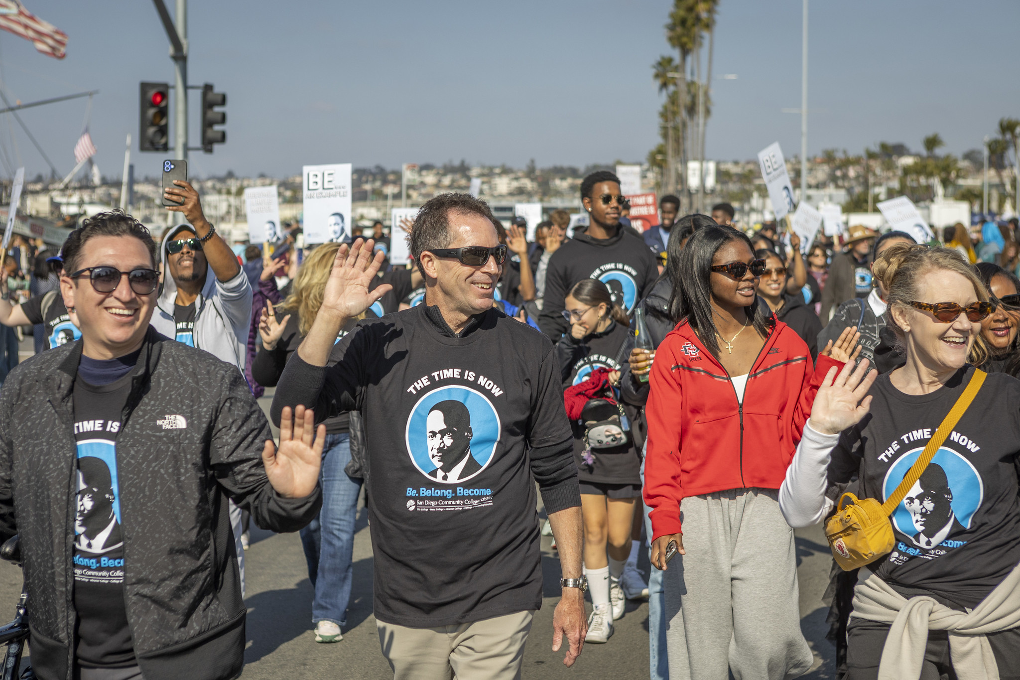 Vice Chancellor of Marketing, Commuications and Public Affairs Jack Beresford waves while walking in the parade.