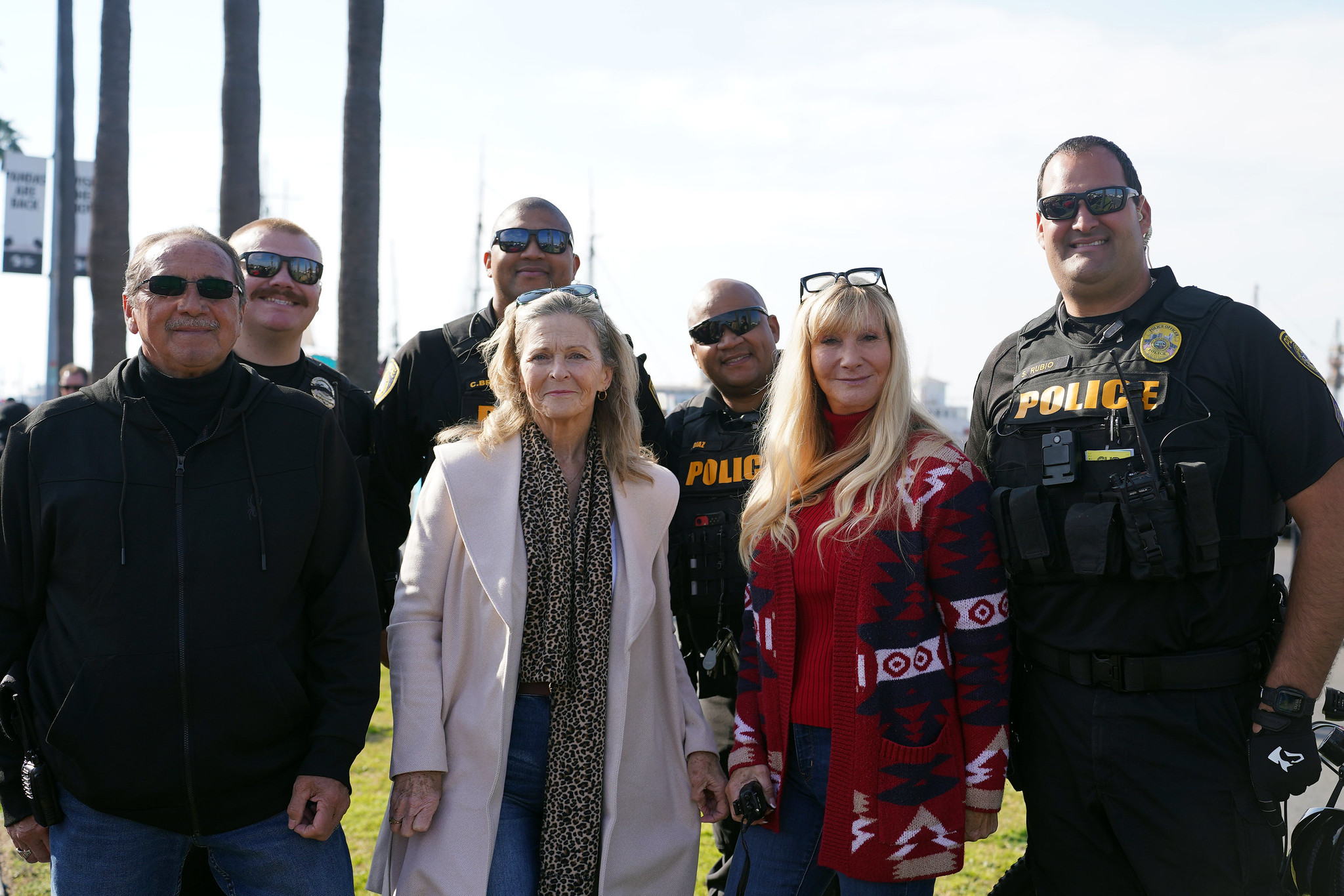 Four college police officers in uniform with four police support staff.