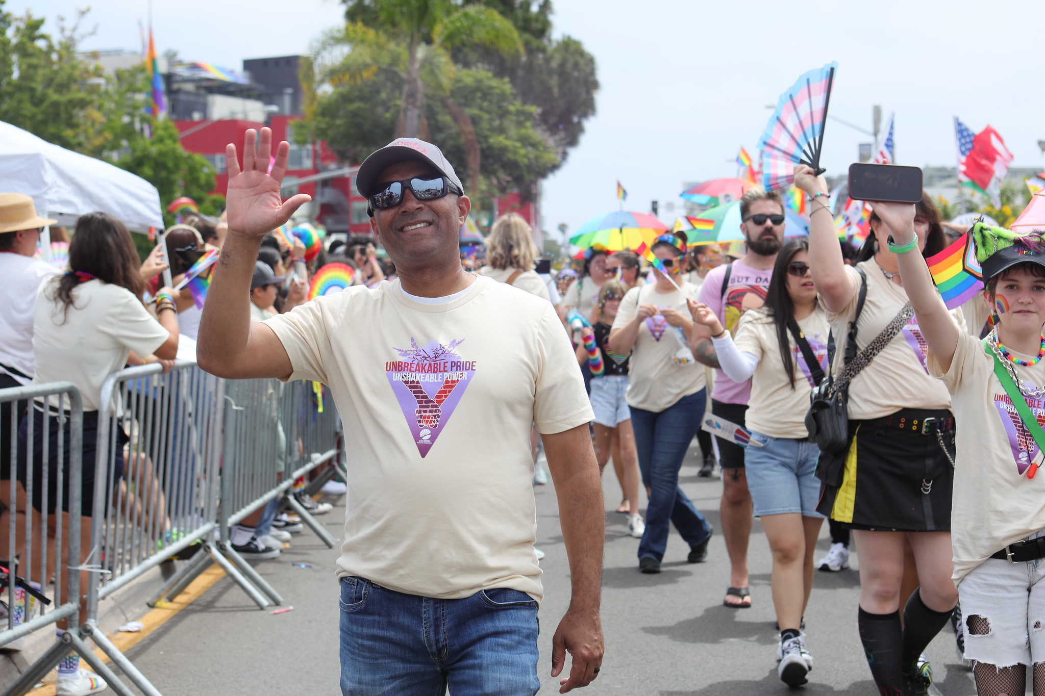 
City College President Ricky Shabazz waves while walking in the parade.
