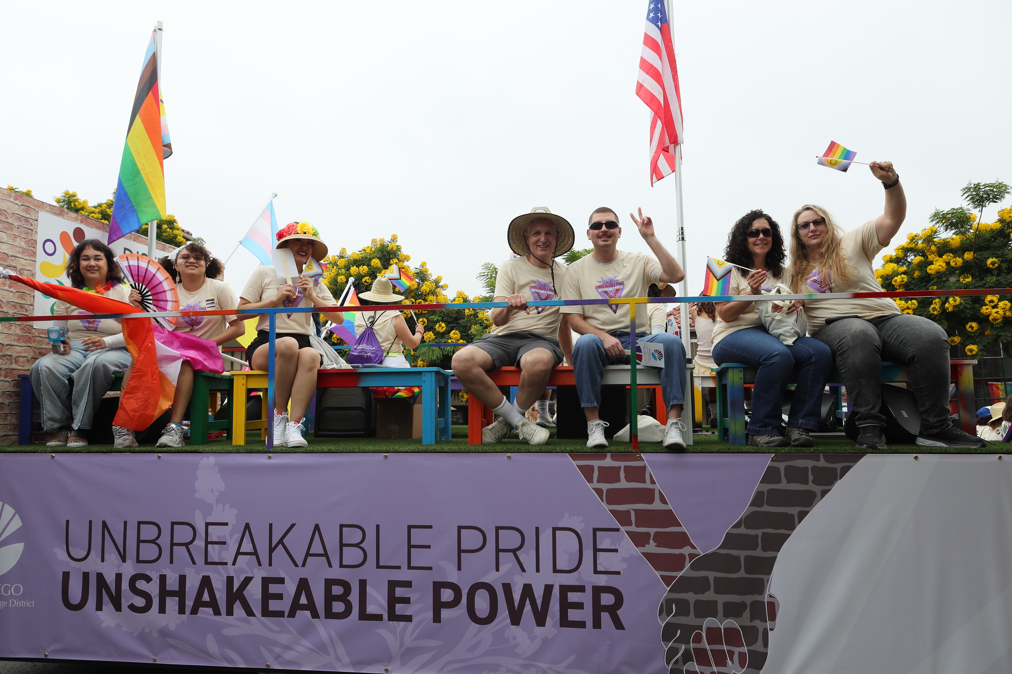 
People on the SDCCD float wave to the crowd.
