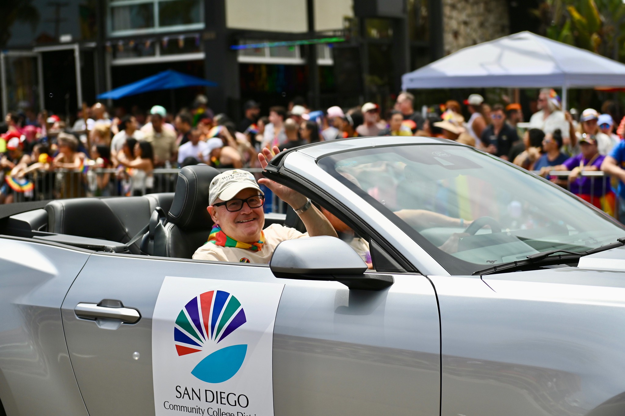 
Trustee Craig Milgrim riding in a convertible car in the parade.

