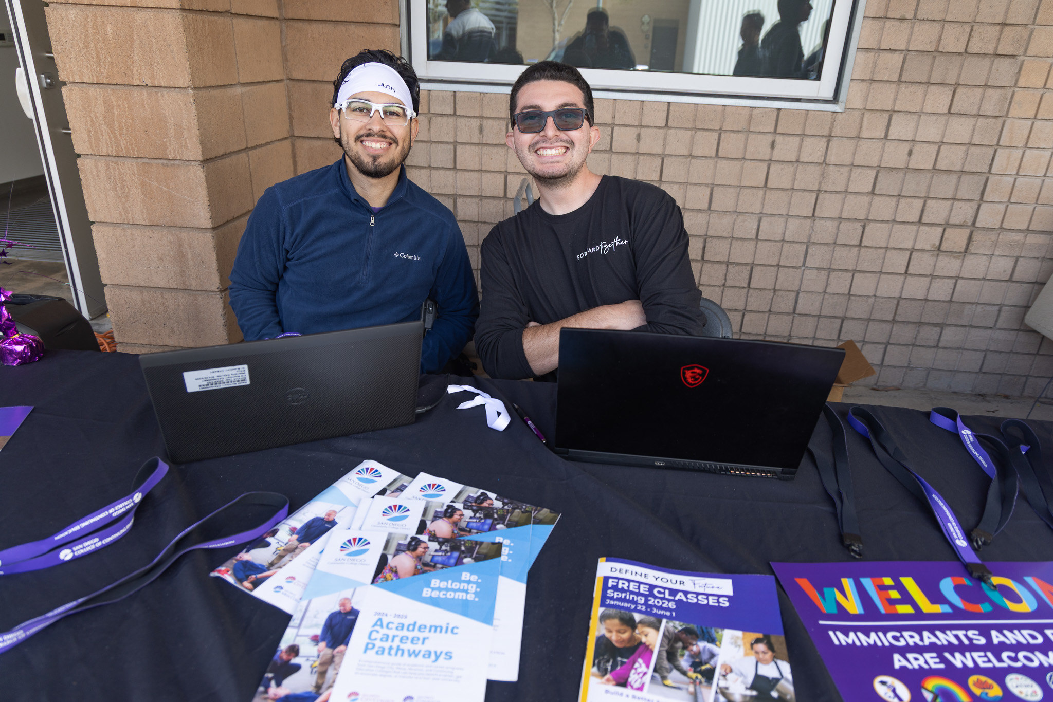 
Two people working a welcome table at College of Continuing Education.
