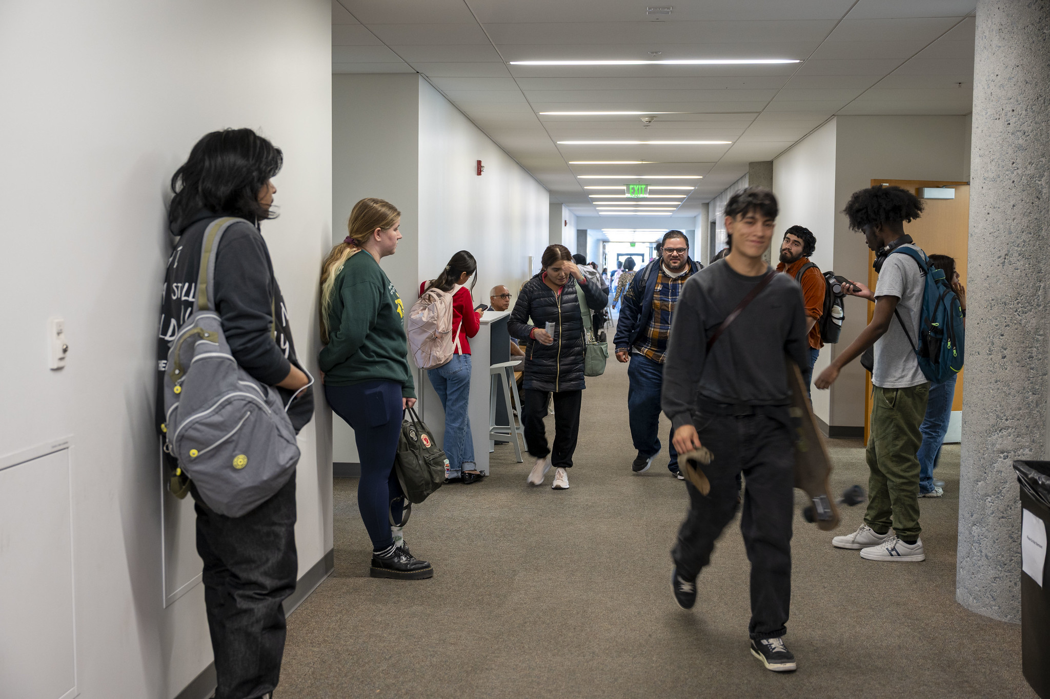 
Students head to class in a hallway at City College.
